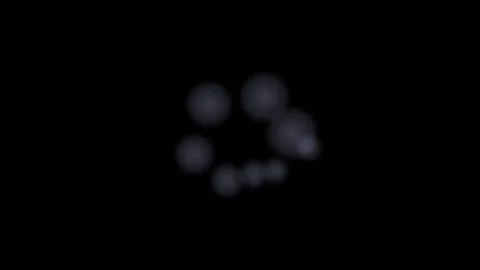 A circular array of soft glowing orbs against a deep black background Video stock 335118346