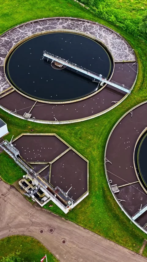 Circular basins processing sewage at a modern water treatment facility from 库存影片 339646619