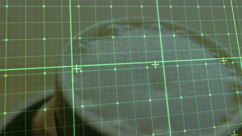 Circular beige disc rotating under green grid, highlighting scanning interface Stock Footage 307445436