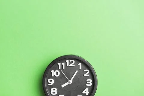Circular black clock green wall backdrop Stock Photos