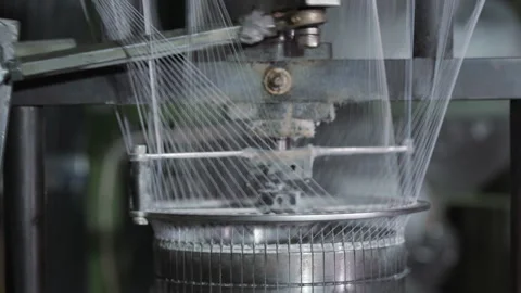 Circular braiding machine forming tight pattern with fast moving white threads Stock Footage 321891055