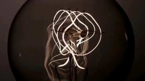Circular bulb filaments glow brightly and then slowly fade Video stock 329657341