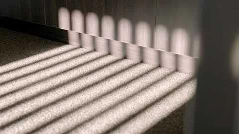 Circular camera movement capturing sunlight patterns through railing creating Stock Footage 329003043