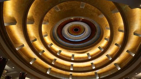 Circular ceiling design with intricate patterns and warm lighting 스톡 사진