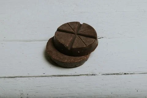 Circular chocolate bars on wooden planks 库存照片