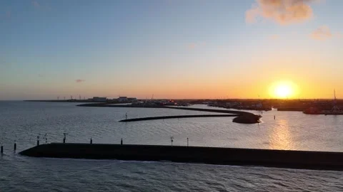 Circular dawn flight around pointed harbor breakwater Stock Footage 331841488