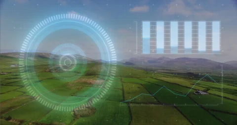 Circular digital interface floating over green farmland while bar charts and 스톡 동영상 307443898