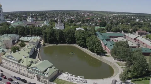 Circular drone ascent over pond in urban area Video stock 331740683