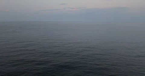 Circular Drone Movement Over Ocean at Sunset Stock Footage 327329554