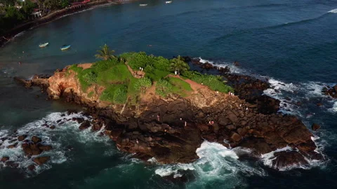 Circular drone orbit around Parrot Rock Island in Mirissa Stock-Footage 316751692