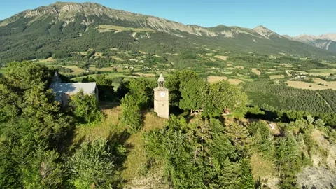 Circular drone shot, of the historic clock tower in a French mountain Stock Footage 312961799