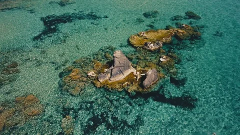 Circular Drone Shot Over a Rock in the Middle of the Mediterranean Sea Near Stock Footage 311589979