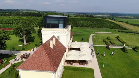 Circular flight above a beautiful building among green fields Stock Footage 112333231