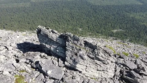 Circular Flight Around Mountain Summit with Rocky Slopes and Sky Video stock 313453905