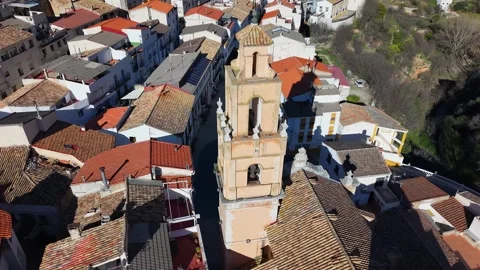 Circular flight over the bell tower of a church in a mountain village Stock Footage 344054495