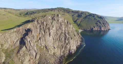 Circular flight over the rocky cliff of Baikal Stock Footage 93307378
