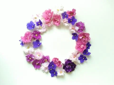 Circular floral frame of multi-colored violets flowers Stock Photos