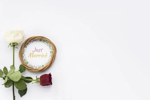 Circular frame with just married text flowers white surface Stock Photos