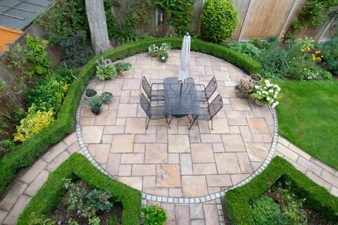 Circular garden patio with freshly jet washed paving stones Stock Photos
