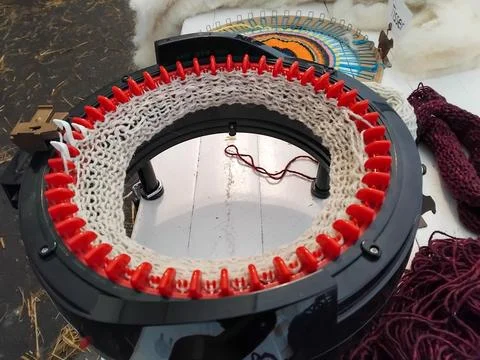 Circular knitting machine with colorful threads in Dordogne France exhibition Stock Photos