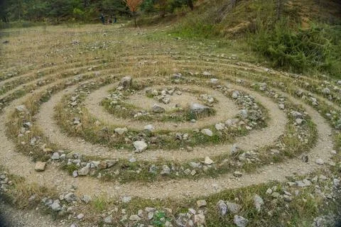 Circular labyrinths on the ground of grass and stones near the Konepruske cave. Stock Photos