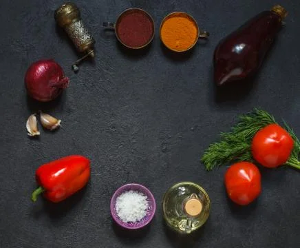 Circular layout of fresh vegetables and spices on a black background Stock Photos