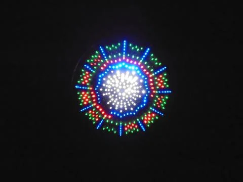 Circular LED light installation at night, radial RGB pattern Foto stock