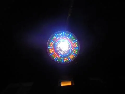 Circular LED light installation at night with radial multicolor pattern Stock Photos