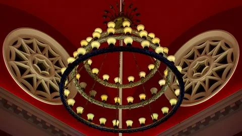 Circular light fixture with decorative elements suspended from the ceiling Stock Photos