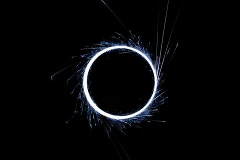 Circular lights with sparks on a black background Stock Photos