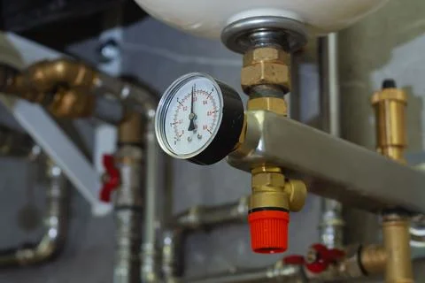 Circular manometer installed on a brass fitting of a domestic heating system. Stock Photos