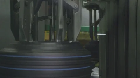 Circular Mechanism with Hooks Rotating Rubber Tires Closeup Stock Footage 84250574
