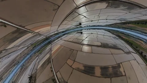 Circular mirrors reflect sky and trees above Видео 345397707