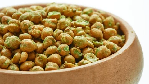 Circular motion beans with wasabi sauce in wooden bowl, isolated on white bac Stock Footage 117332573