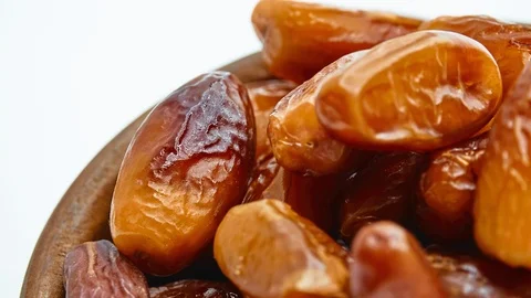 Circular motion Sweet dates in wooden bowl isolated on white background. Stock Footage 116709713