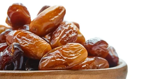 Circular motion Sweet dates in wooden bowl isolated on white background. Stock Footage 116806954