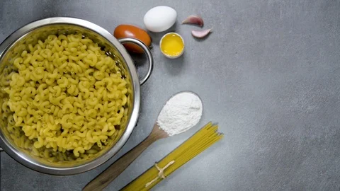 Circular moving drainer with pasta spiral. Gray background with kitchen detai Stock Footage 113629372