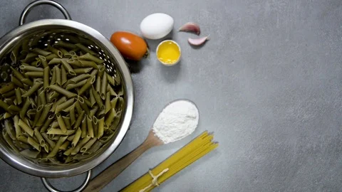 Circular moving drainer with vegan pasta. Gray background with kitchen detail Stock Footage 113632902