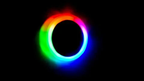 Circular neon light effect featuring a vibrant multicolor gradient emitting.. Stock Photos