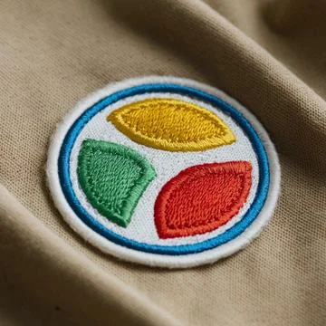 A circular patch or embroidered desin with three colorful sections design Stock Photos