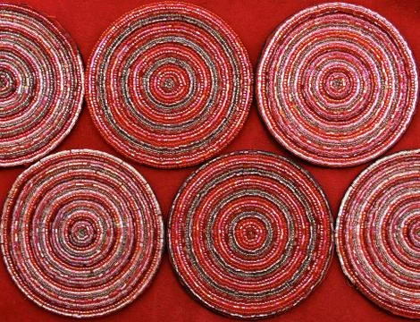 Circular pattern of pink beaded coasters Stock Photos