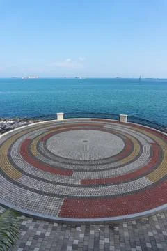 Circular Pattern Stone Plaza on Coastal Waterfront 스톡 사진
