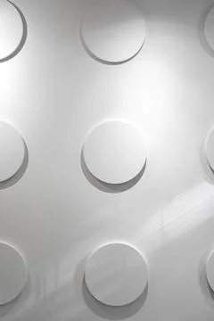 Circular patterns create a unique texture on a modern wall in a bright interior Stock Photos