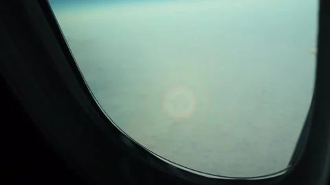 Circular rainbow (Glory of the pilot) optical phenomenon from plane window Stock Footage 233898590