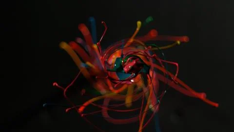 Circular rainbow paint splattering towards camera Stock Photos