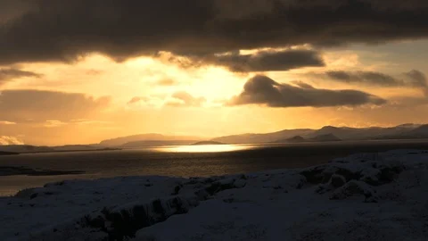 Circular ray of sunlight shining on a beautiful lake during winter near sunset Stock Footage 93469812