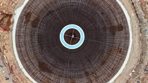 Circular rebar cage for a wind turbine concrete foundation in aerial top down Stock Footage 340265095
