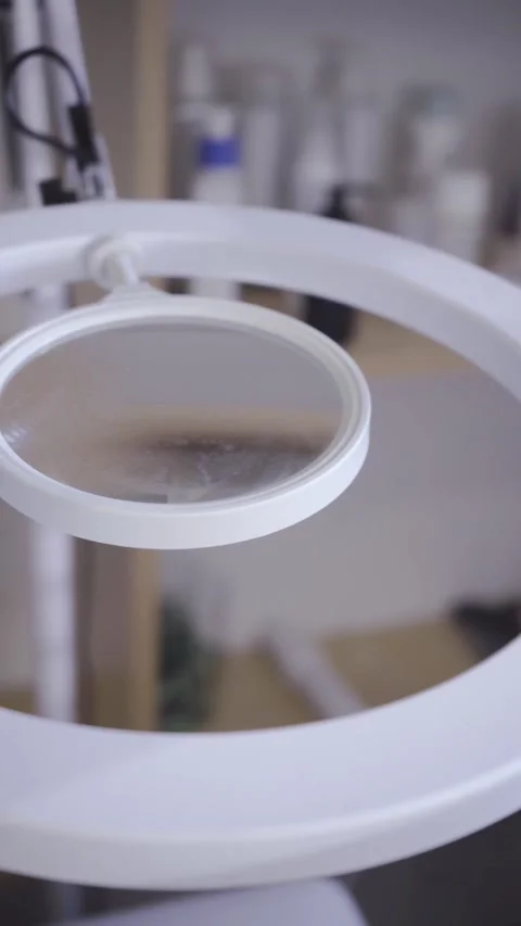 Circular ring light glowing in a quiet beauty studio Stock Footage 342820580