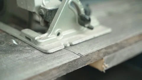 Circular saw base plate cutting a wooden board close-up. Power tool blade Stock Footage 343239185
