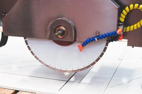 Circular saw cuts marble stone slab with sharp blade.  rotating blade precise Stock Photos
